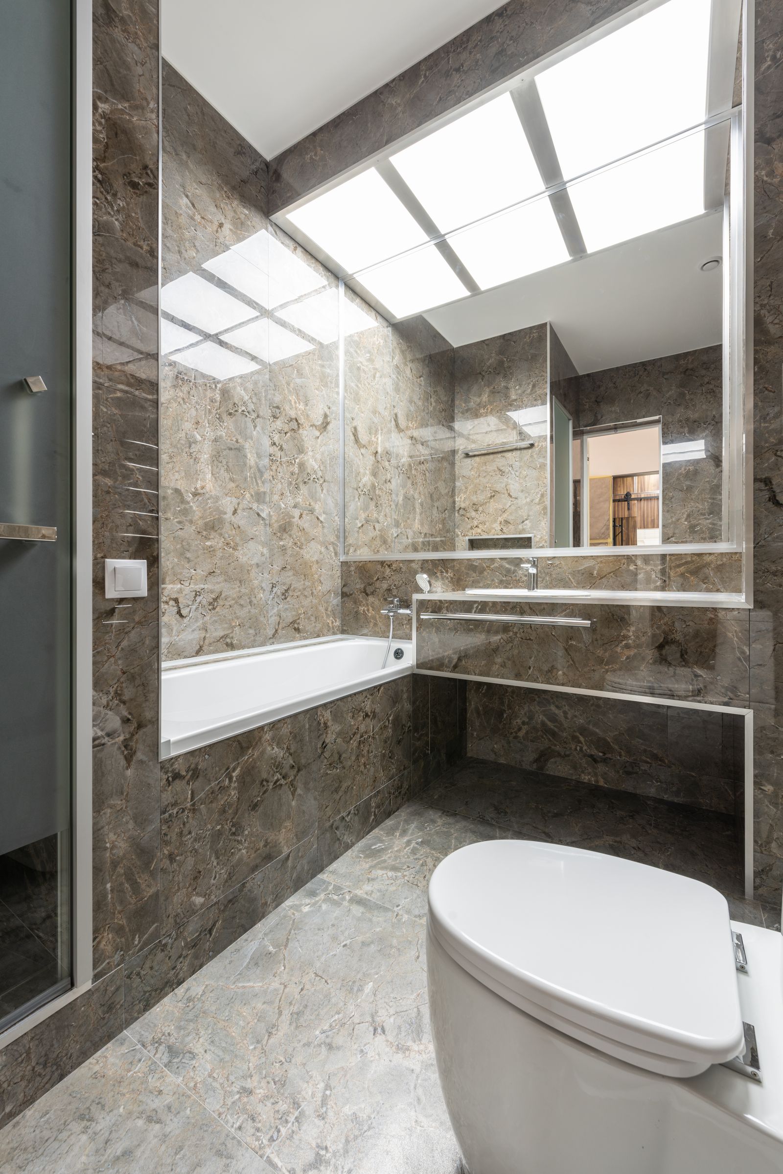 Remodeled marble bathroom with freestanding soaking tub