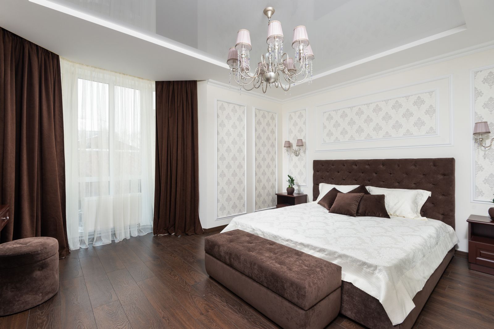 Elegant bedroom with chandelier by Reynolds Interior Design