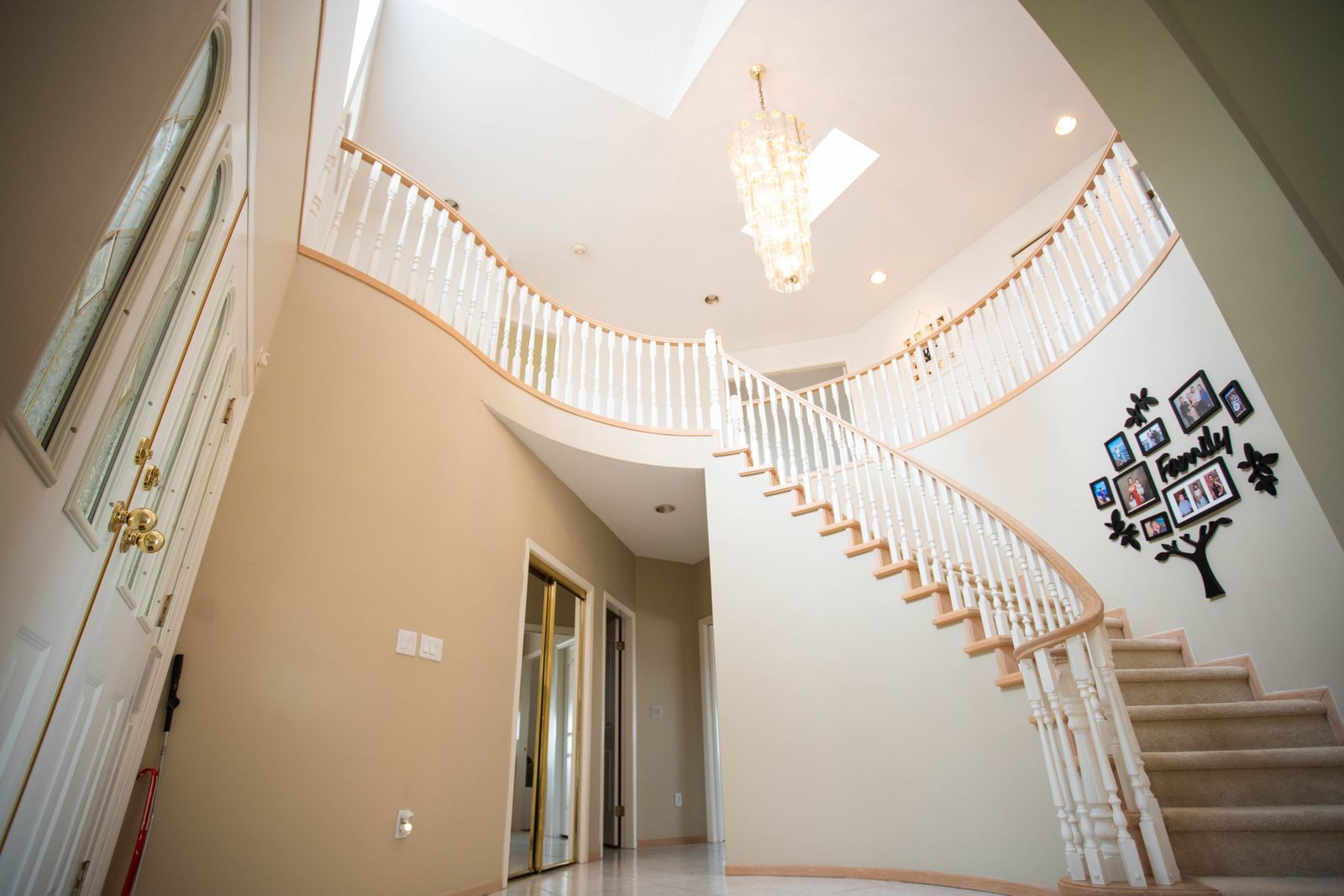 Grand staircase in a traditional entry hall