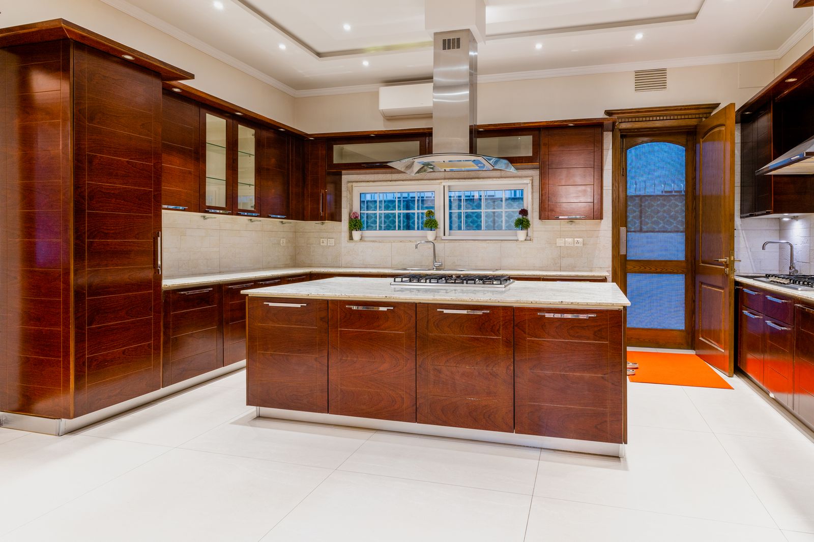 Custom walnut kitchen with large stone-topped island