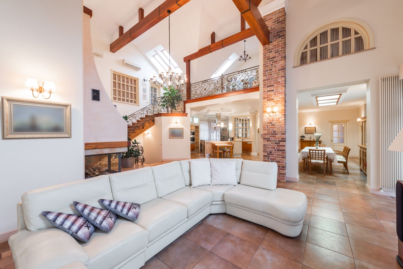Open-concept living room with vaulted wood-beam ceiling, designed by Reynolds Interior Design