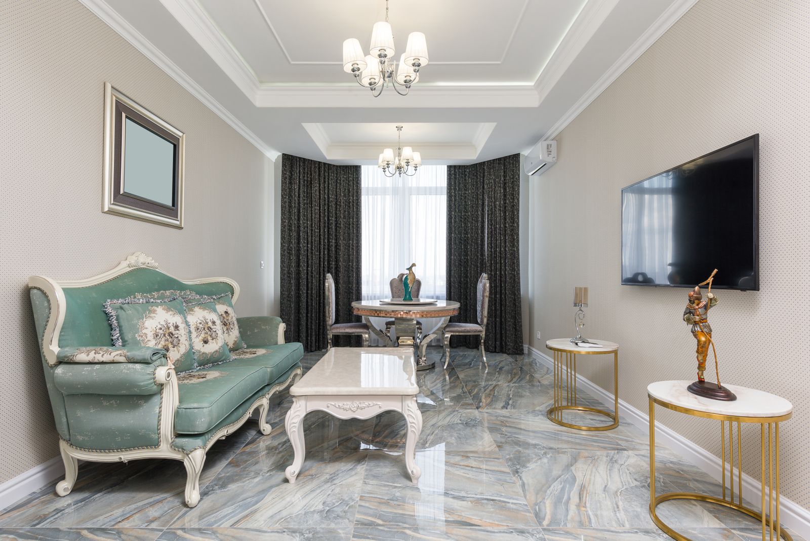 Elegant formal living room with sage upholstery, marble floors, and brass accents