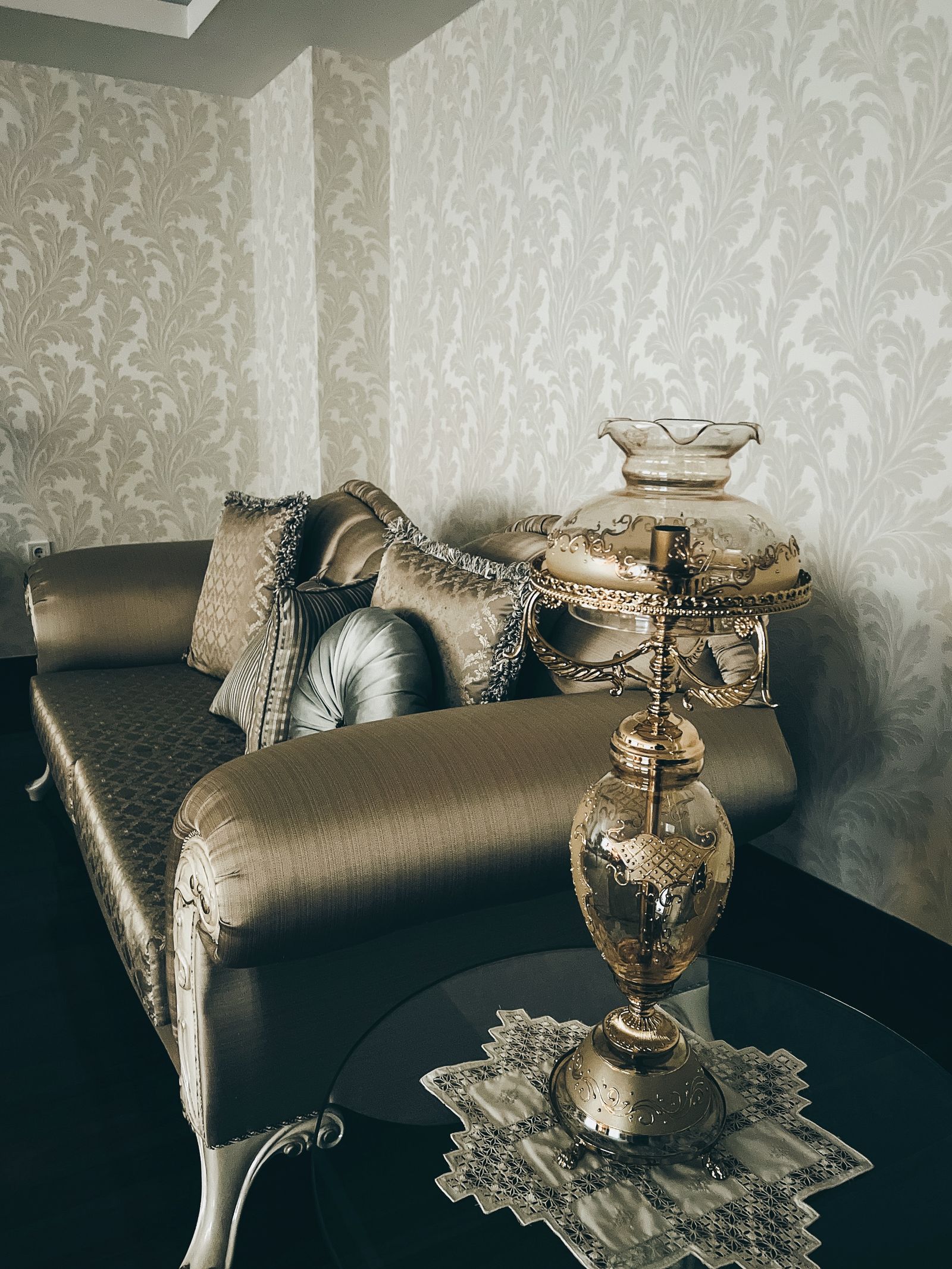 Refined sitting area with sheen upholstery and brass details